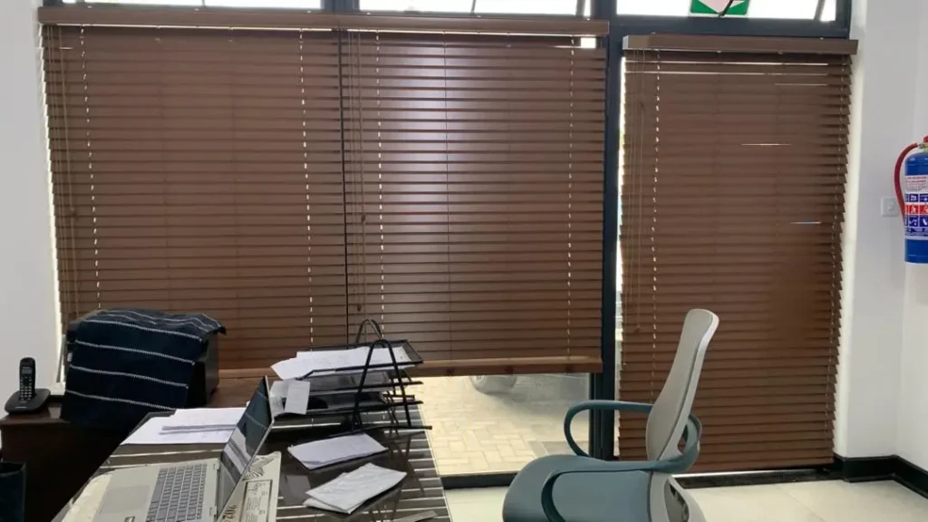 These rich walnut wooden blinds bring serious executive presence to the space.